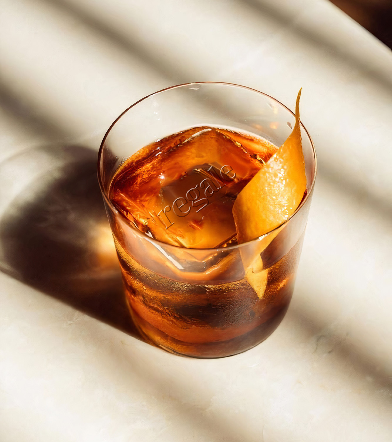 Amber Regale cocktail with an orange peel garnish