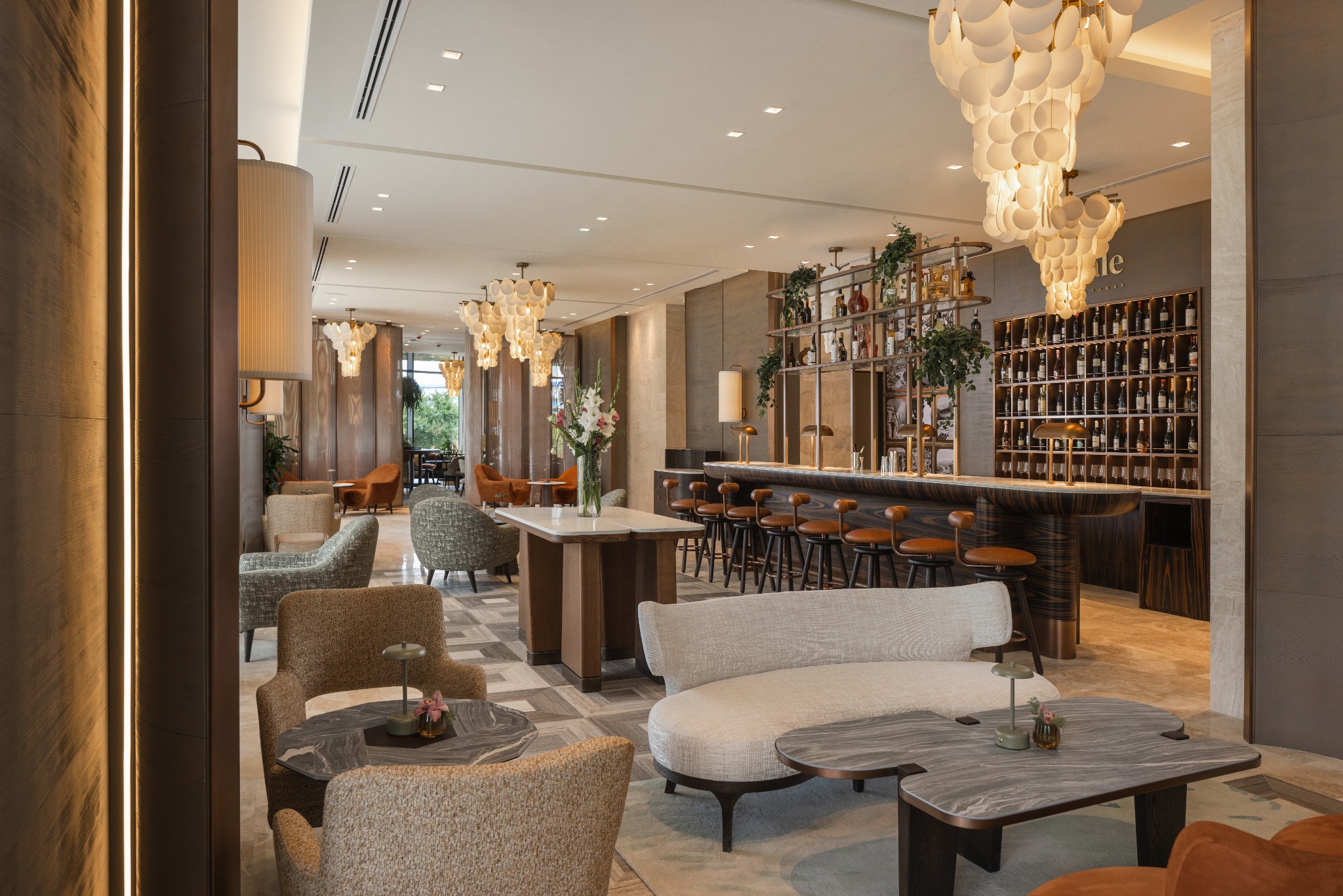 Regale Bar & Lounge at Hilton Prishtina, with warm lighting, lounge seating and the bar
